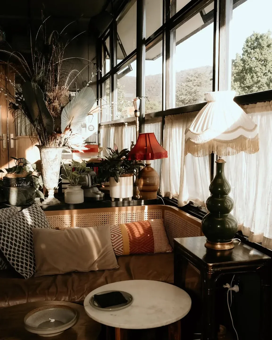 Cozy corner at Wakefield’s in Canberra with plants, lamps, and a view.
