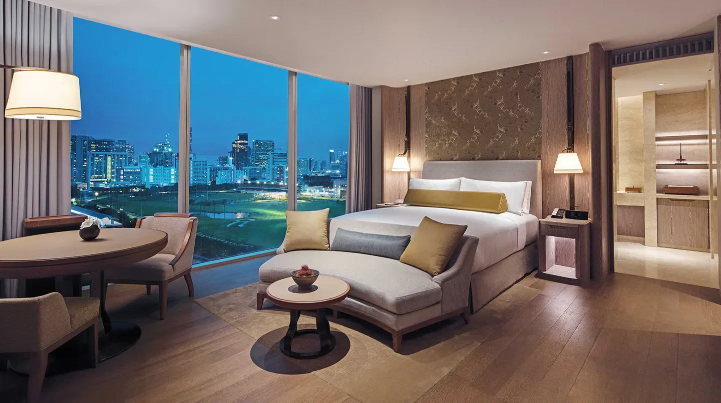 Waldorf Astoria Bangkok suite with city views at night in Bangkok, Thailand.