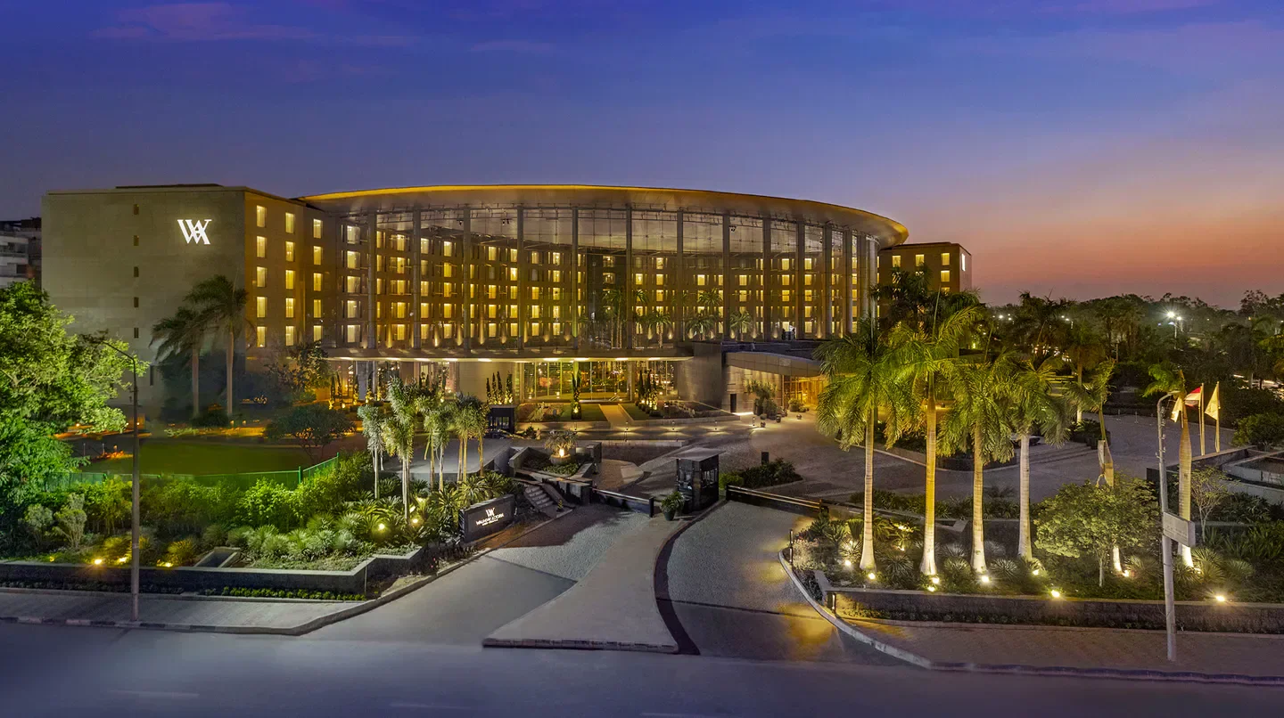 Waldorf Astoria Cairo Heliopolis illuminated at dusk in Cairo, showcasing modern architecture
