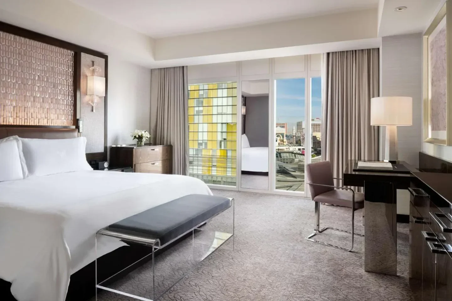 Luxury bedroom at Waldorf Astoria Las Vegas with city views of Las Vegas.