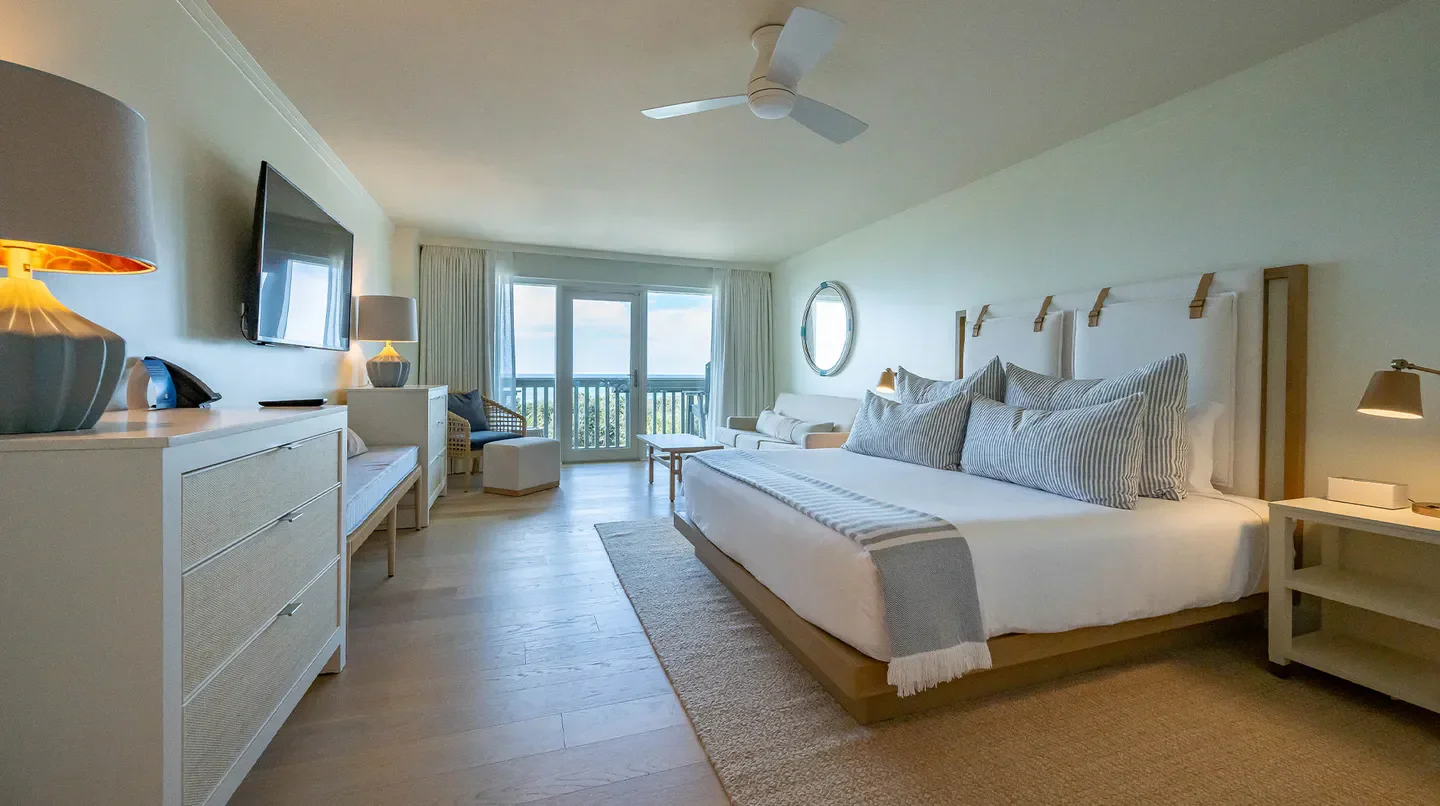 Spacious bedroom at the WaterColor Inn in Tampa with balcony view and elegant decor.
