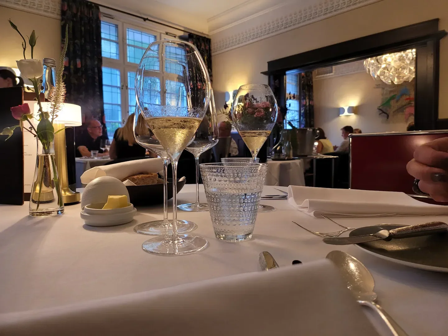 Dining experience at Werneckhof Sigi Schelling, Munich, featuring champagne glasses and elegant table setting