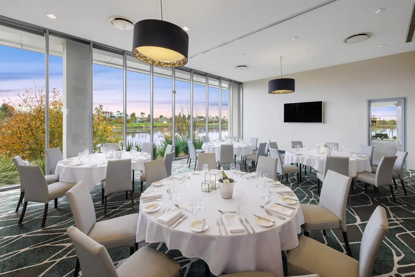 Elegant dining room at WestWaters Restaurant in Melbourne with scenic lake views.