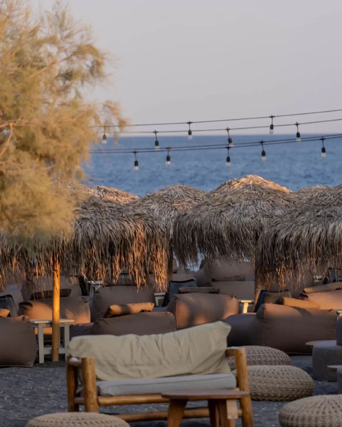 Cozy seating area at Wet Stories restaurant in Santorini with ocean view.