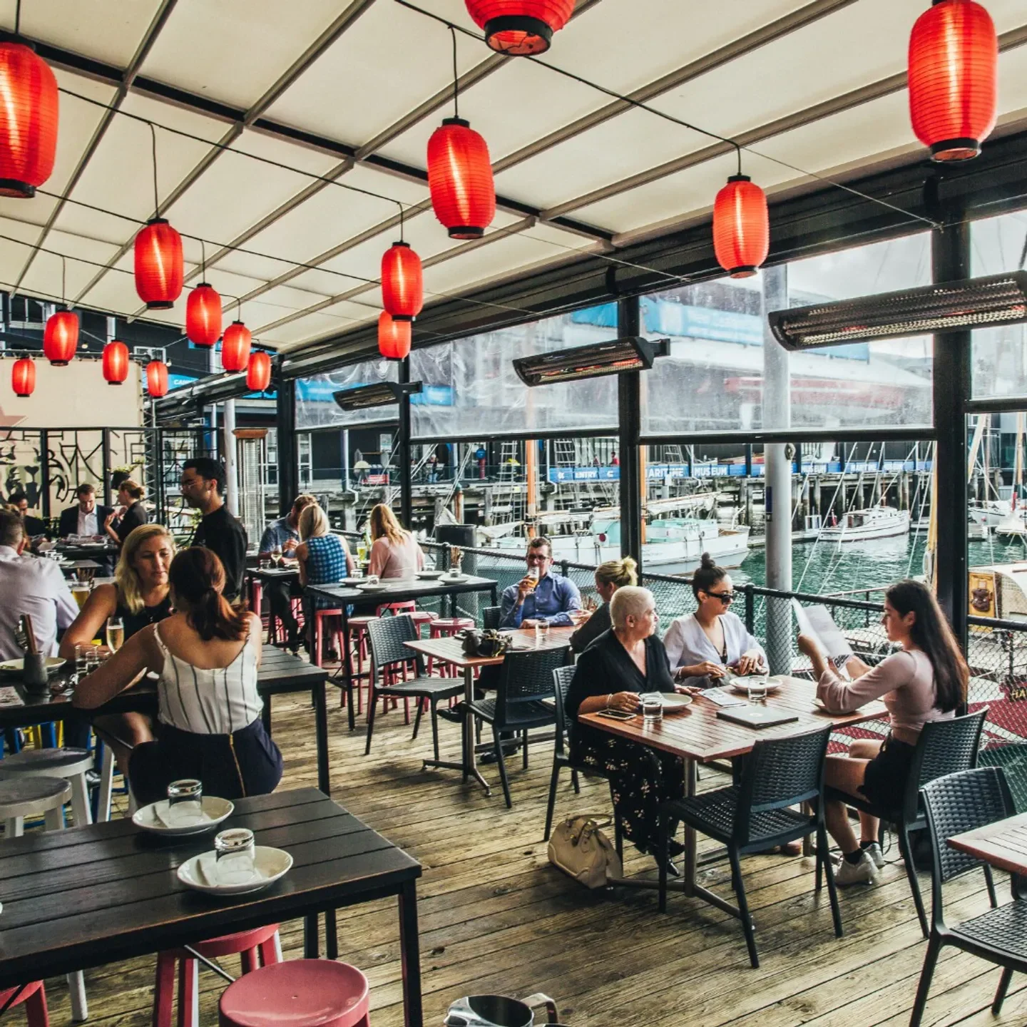 Outdoor dining at White Wong’s in Auckland with red lanterns and harbour views.