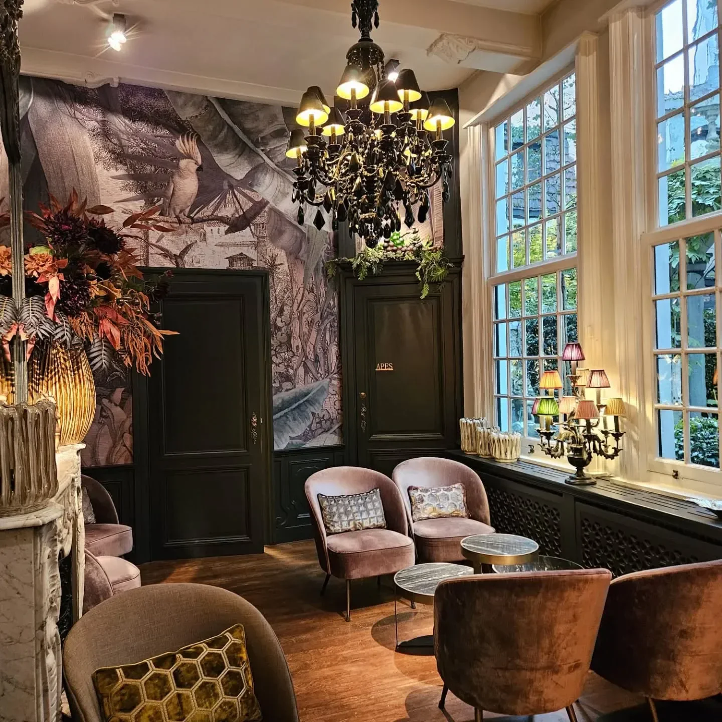 Cozy interior of Wijnbistro Goddaard in Antwerp, featuring elegant seating and a unique mural.