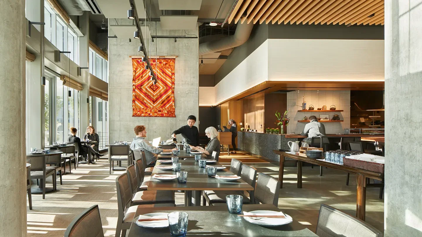 Interior of Wild Ginger restaurant in Seattle. Modern design with tables and art.