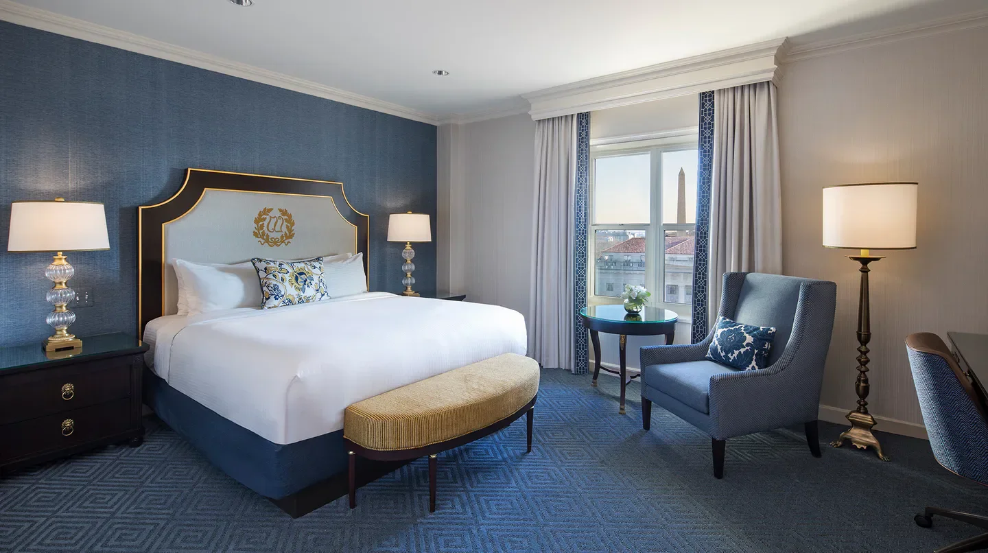 Elegant bedroom at the Willard InterContinental in Washington, featuring city views.