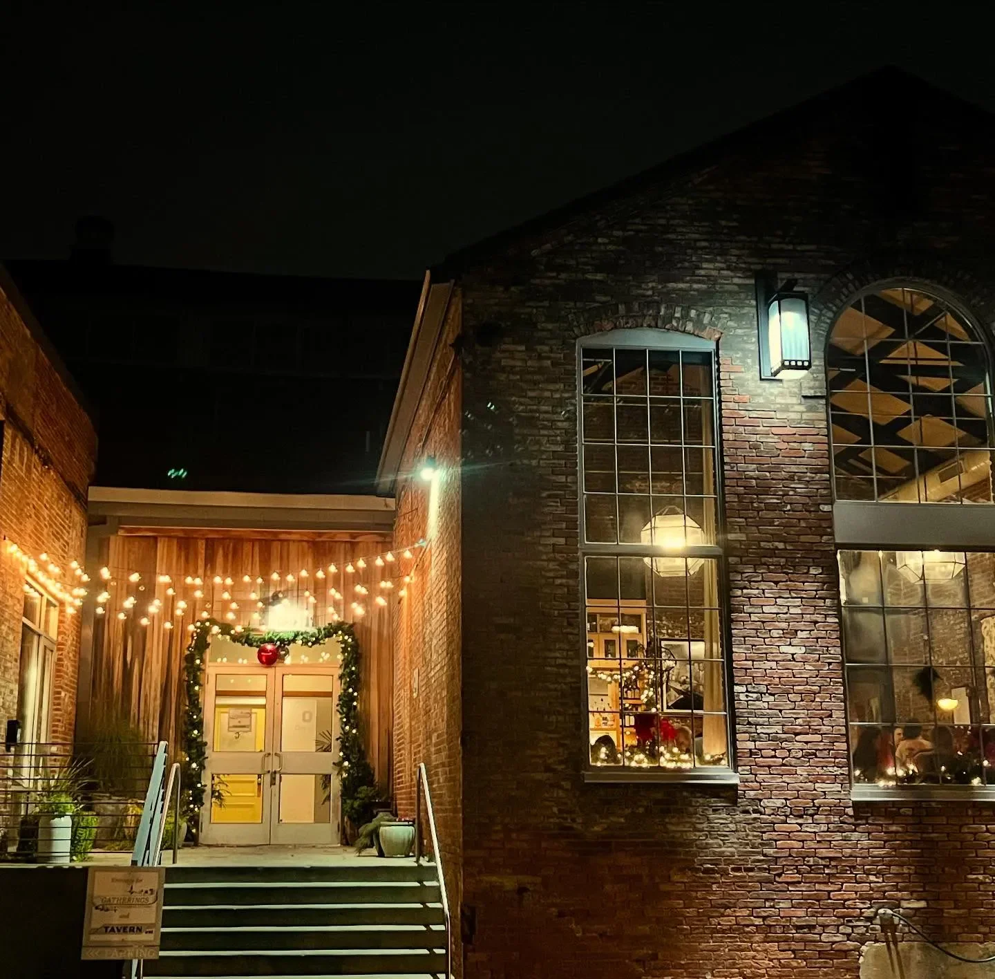 Exterior of Woodberry Kitchen in Baltimore, illuminated at night with festive lights.