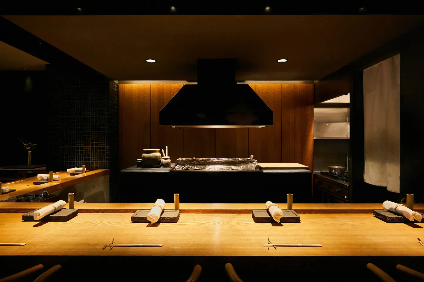 Interior of Yakitori Ichimatsu restaurant in Osaka, showcasing the yakitori grill and seating.