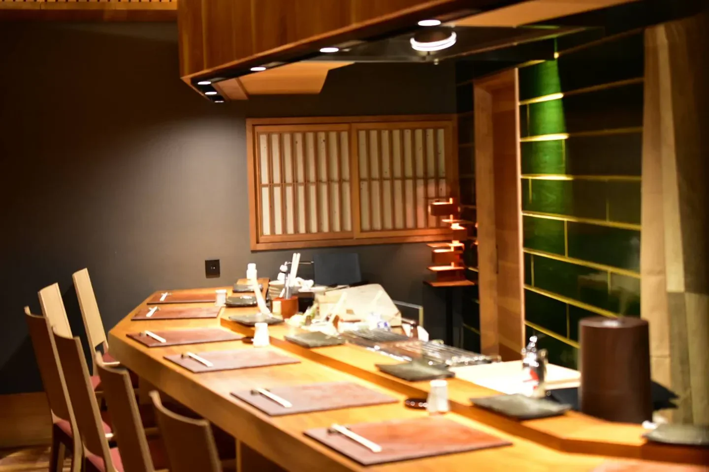 Interior of Yakitori Torisen in Osaka, featuring a wooden bar and seating.