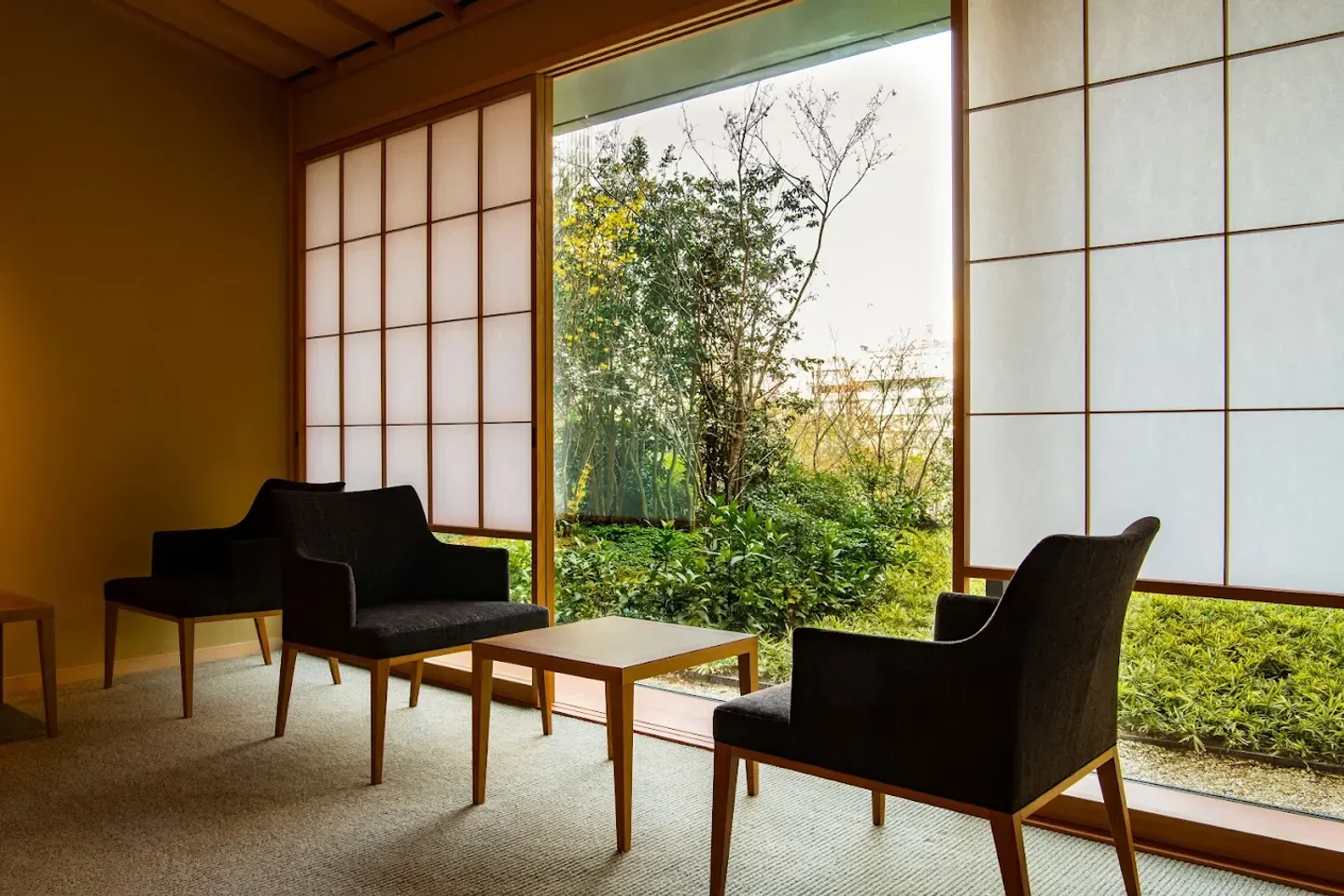Cozy seating area at Yamazato Tokyo restaurant, with a garden view in Tokyo.
