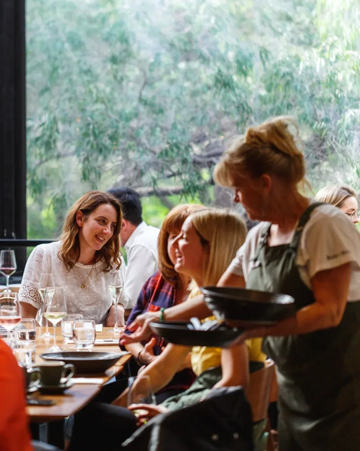 Yarri Restaurant Bar in Margaret River: Waitress serving diners at a table with drinks.