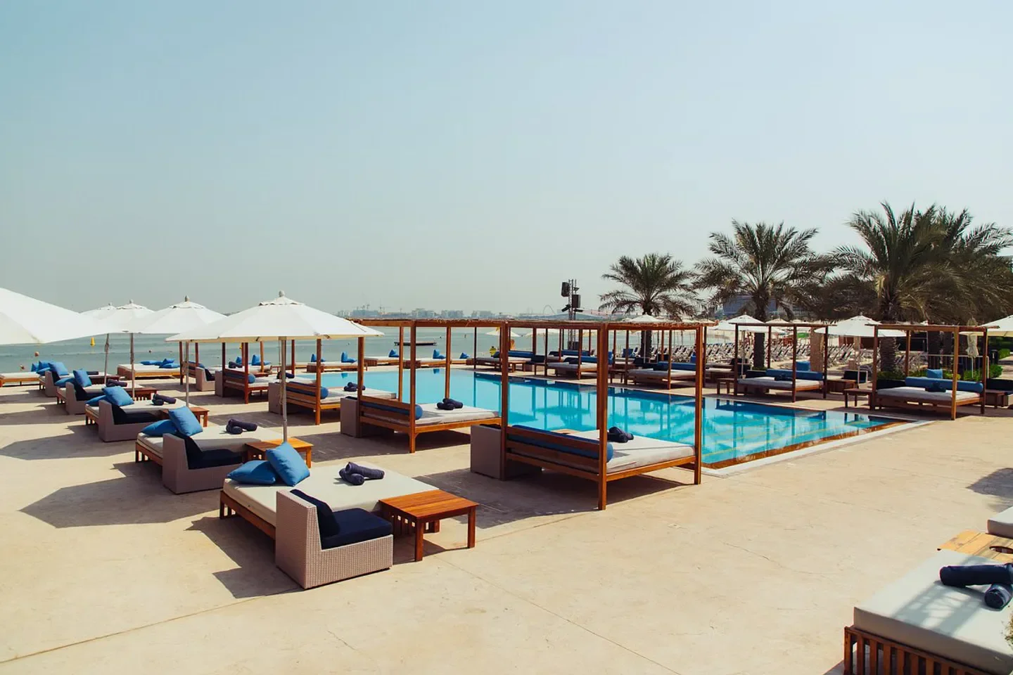 Beach club pool and sunbeds at Yas Beach in Abu Dhabi, perfect for relaxation.