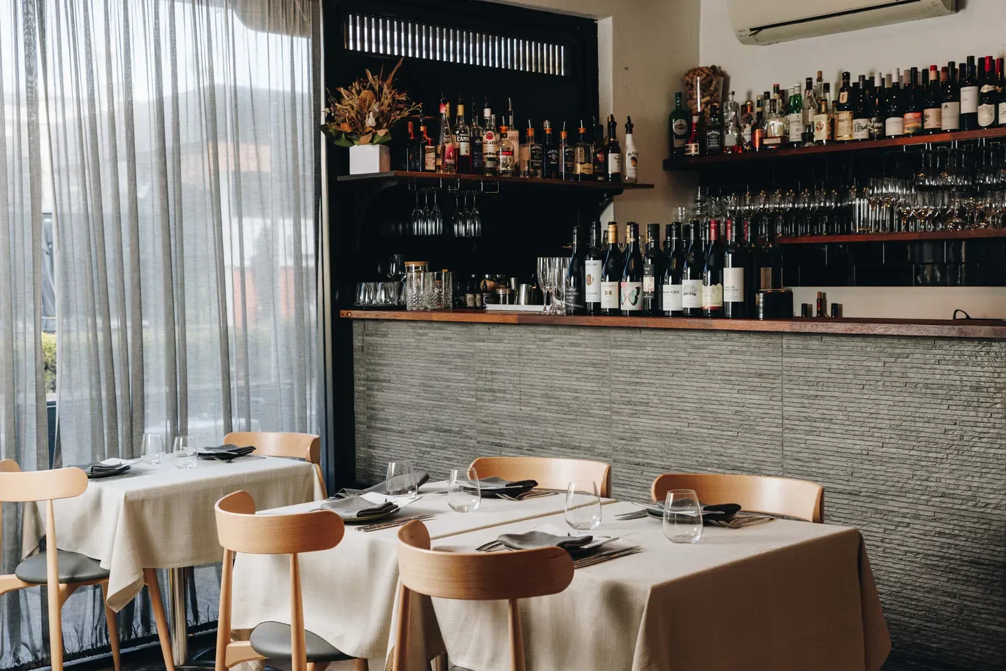 Interior of Yellowtail Restaurant on the Central Coast, featuring dining tables and bar