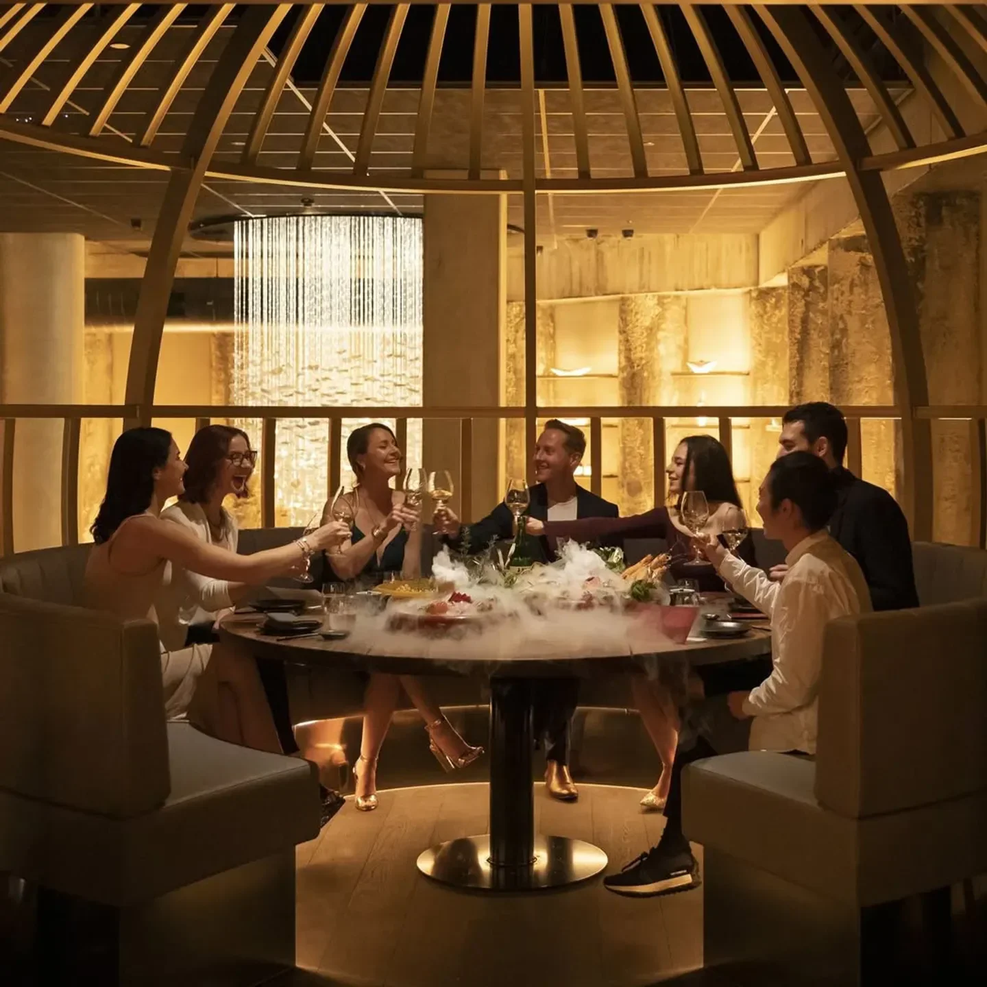Group cheers at Yugen Dining in Melbourne, enjoying elegant dining and drinks.
