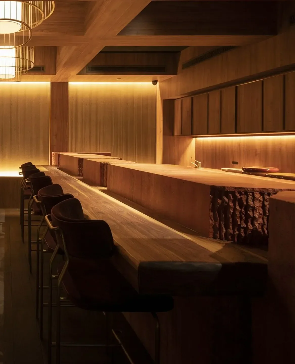 Elegant dining space at Yugen Omakase restaurant in Melbourne, featuring wooden tables and bar seating.