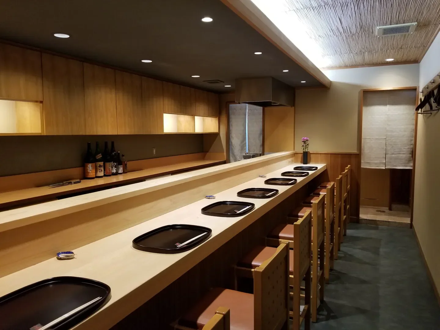 Interior of Yuyu restaurant in Kyoto, featuring sushi bar and seating area.