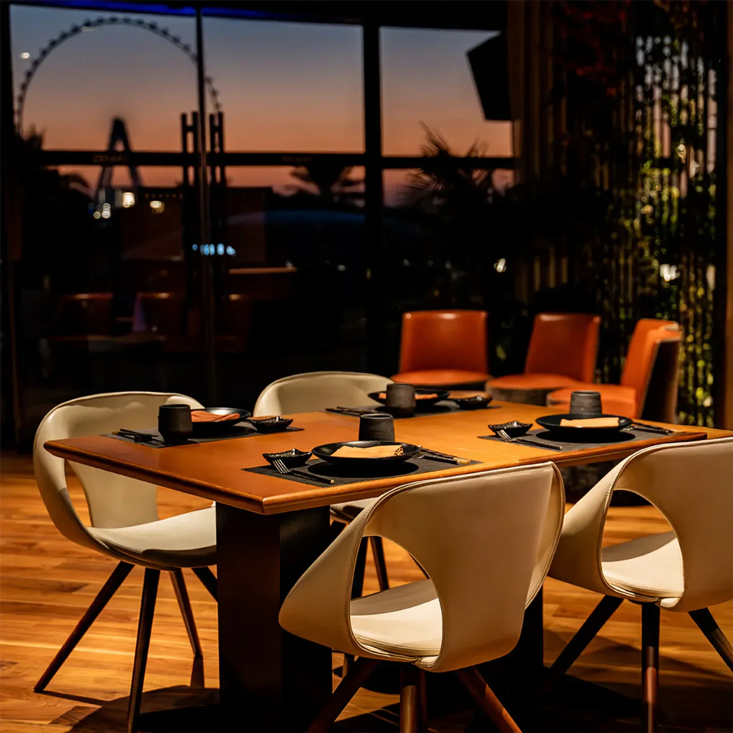 Zengo Dubai restaurant interior with a table set for dinner at sunset with city views