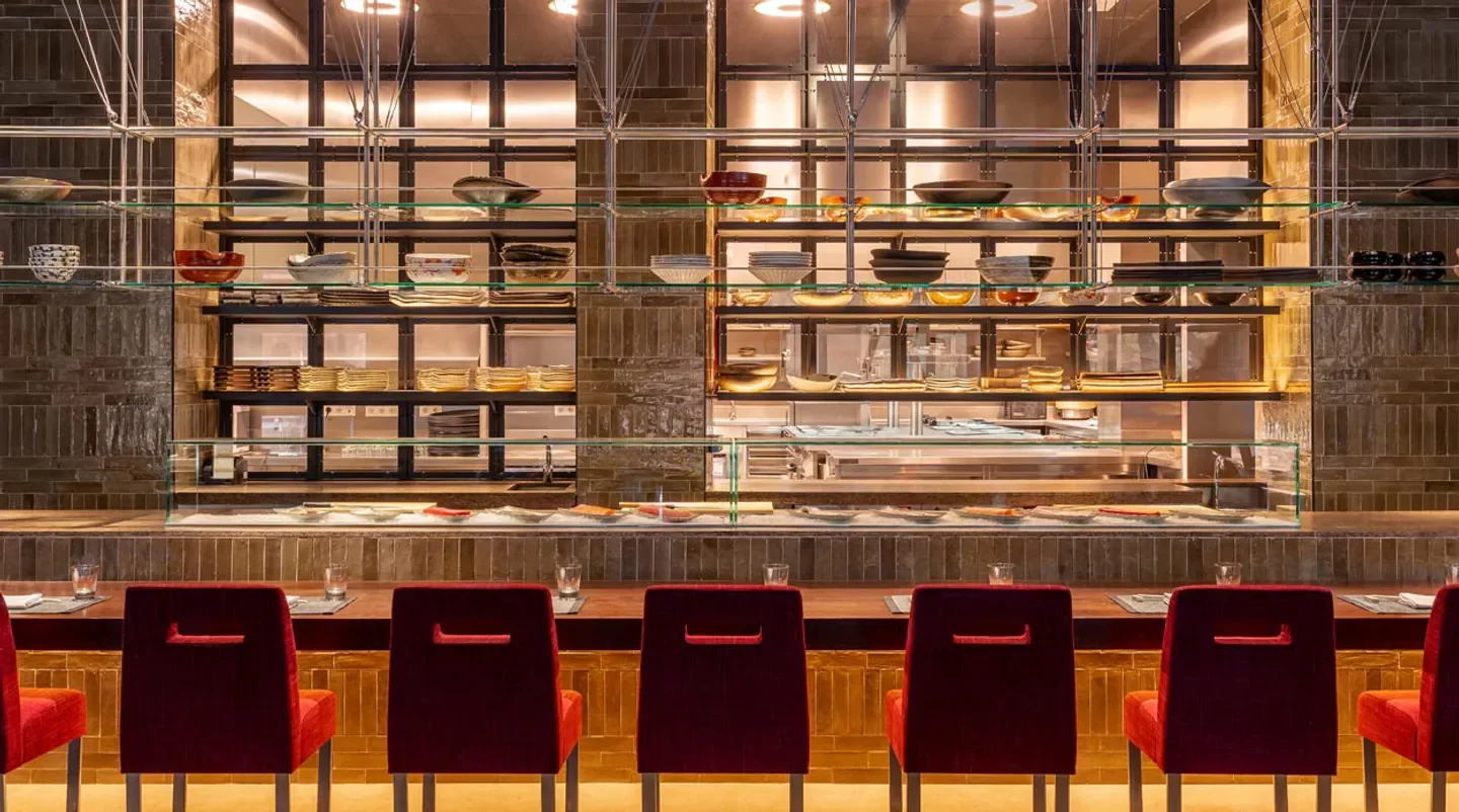 Interior of Zuma Madrid restaurant, showcasing stylish seating and shelves with dishware.